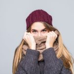 Manchas blancas en la piel &iquest;por qu&eacute; salen y qu&eacute; hacer?: pretty girl in grey sweater and scarf is cold on gray min 150x150 - HeelEspa&ntilde;a